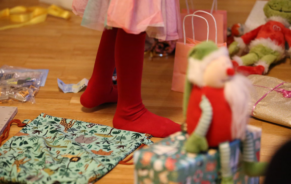 pies de niña con varios regalos en el suelo